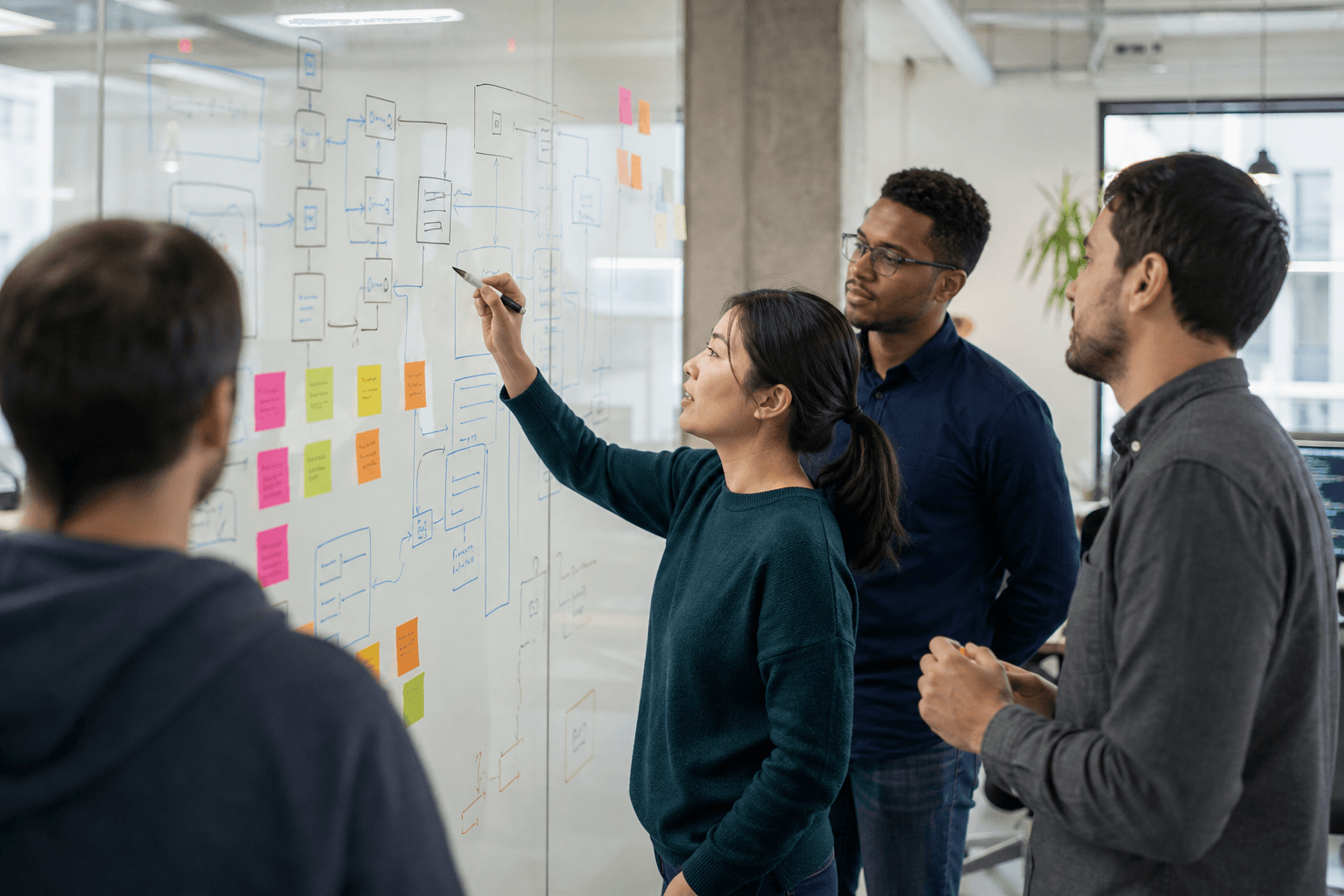 Engineers mapping architecture on a whiteboard